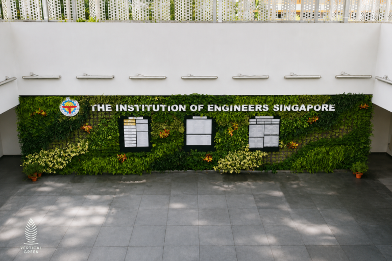 Large living green wall installation displaying The Institution of Engineers Singapore signage in a bright open atrium with contemporary architectural finishes.